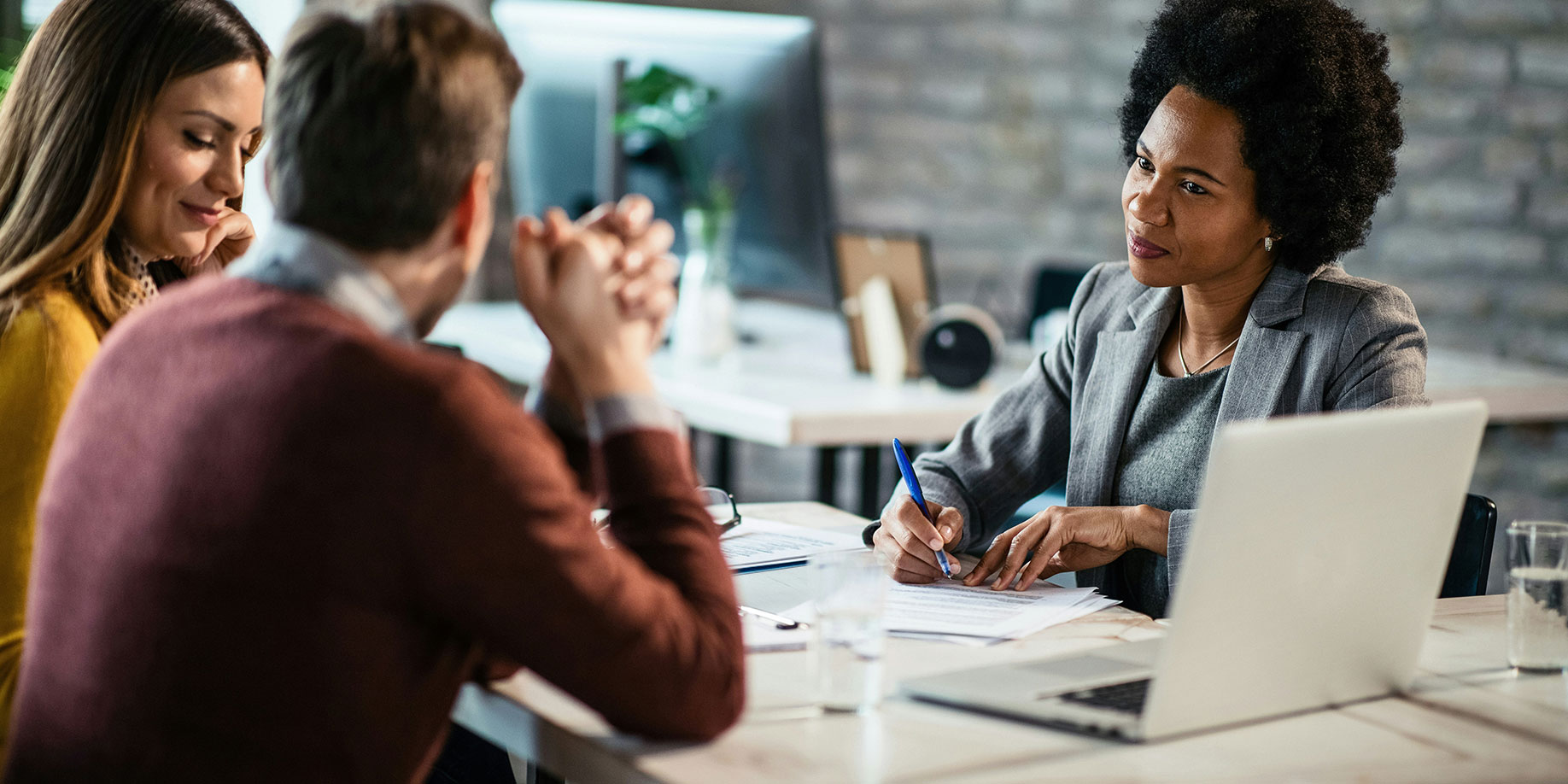 A couple speaking with a tax advisor