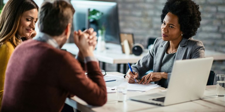 A couple speaking with a tax advisor