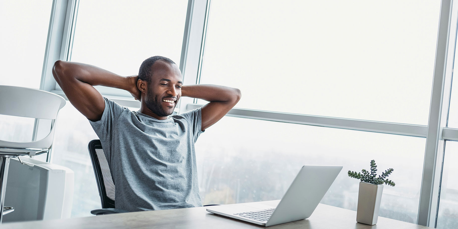 Smiling man setting up his donor advised fund with his laptop