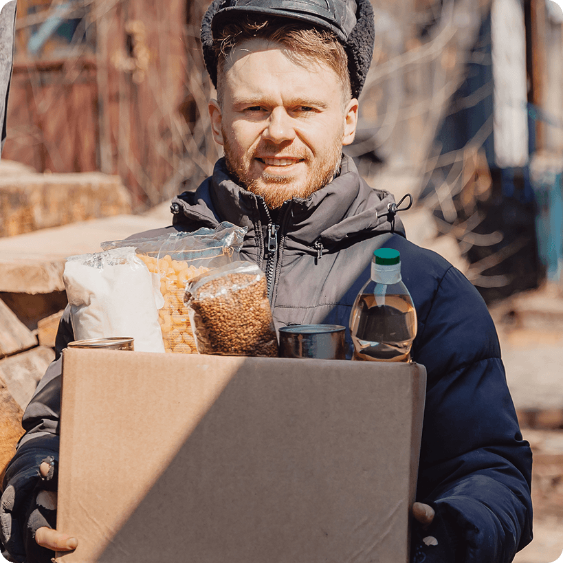 Person holding a box of food donations