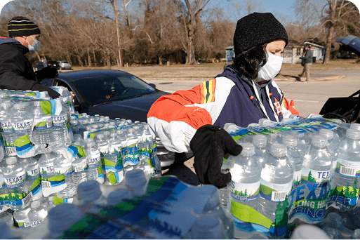 Volunteers unloading palettes of water off of a truck