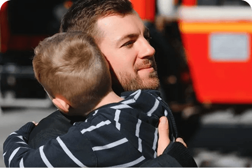 A fireman hugging a child