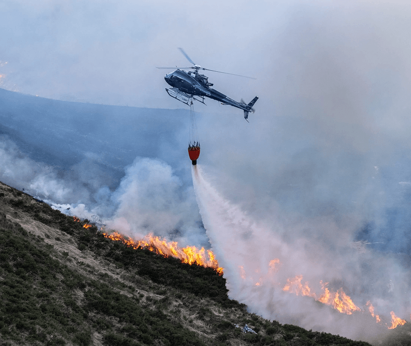 A helicopter battling a wildfire