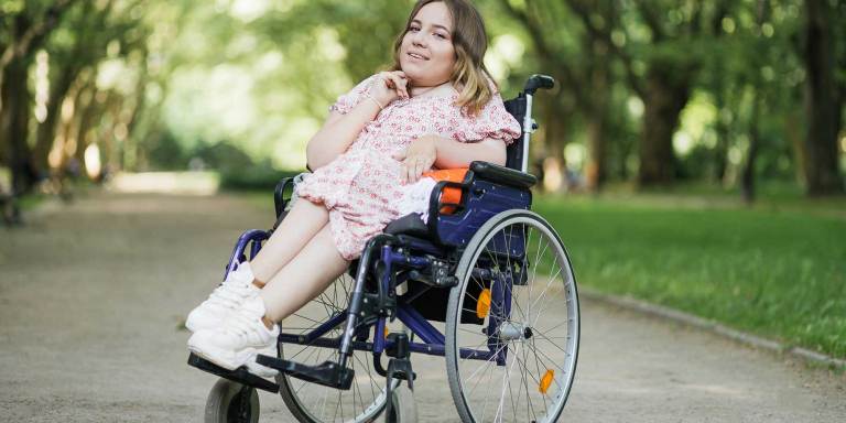 A happy woman in a wheelchair