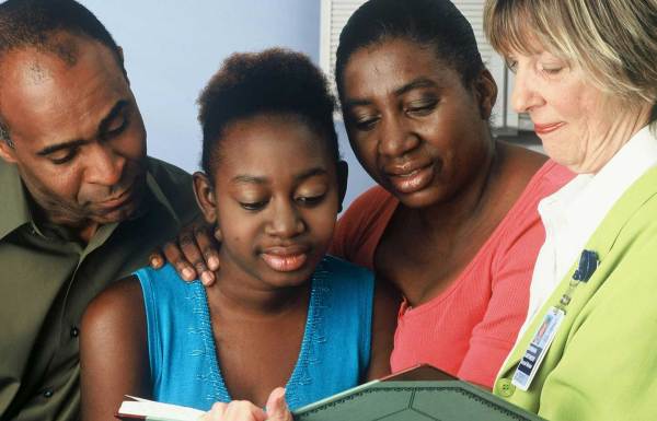 A family receiving support from a medical professional