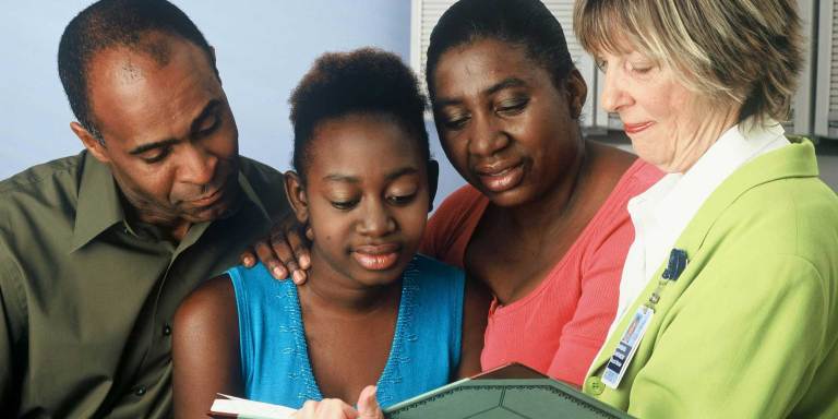 A family receiving support from a medical professional