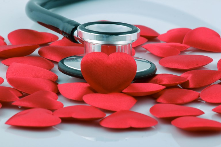 paper red hearts and a stethoscope