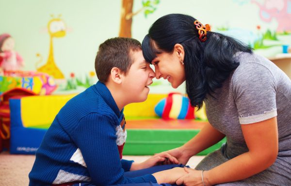 Young kid and mom touching foreheads