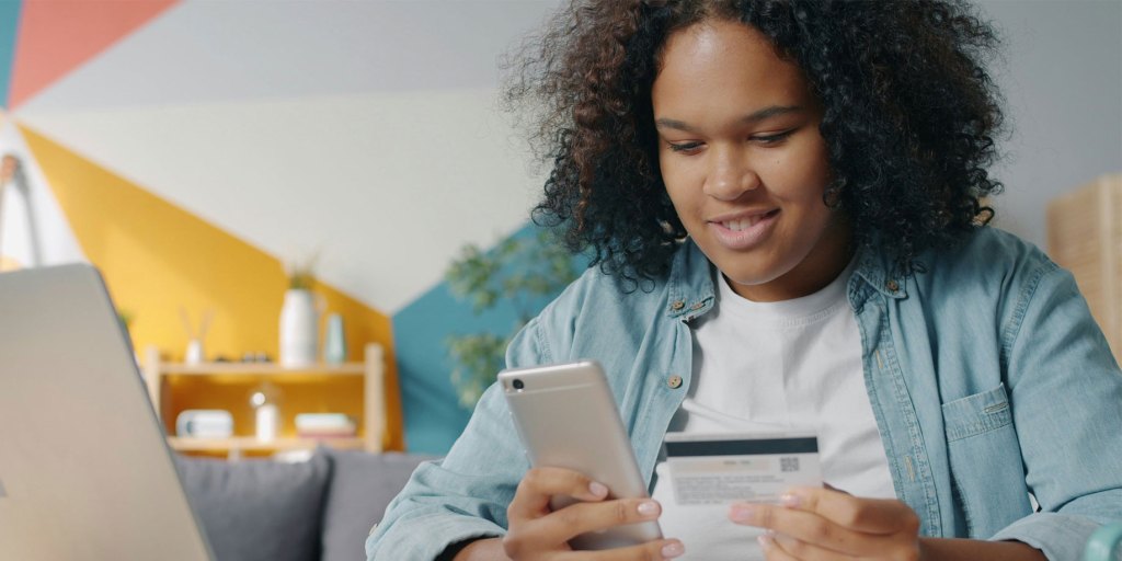 Woman using her phone to enter her account information for her fundraiser