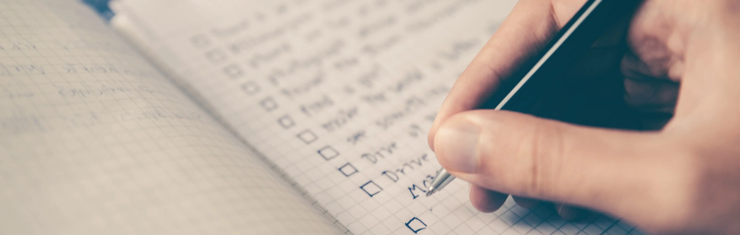 Person's hand writing down on a notepad