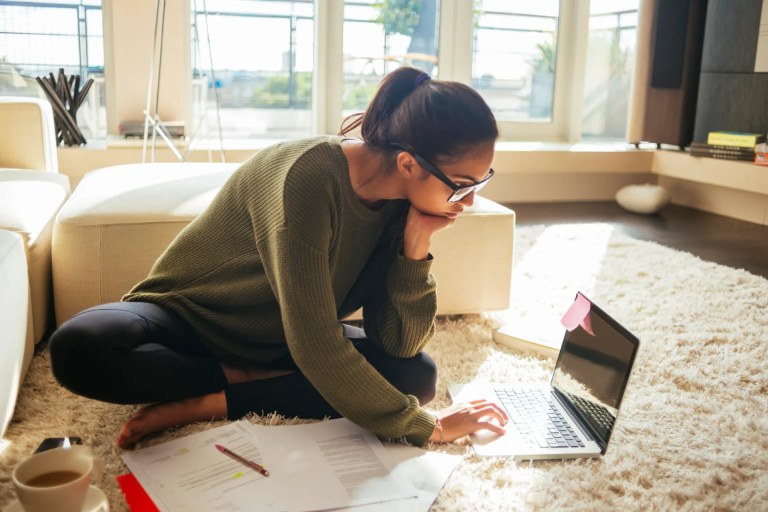 Single mother working on laptop