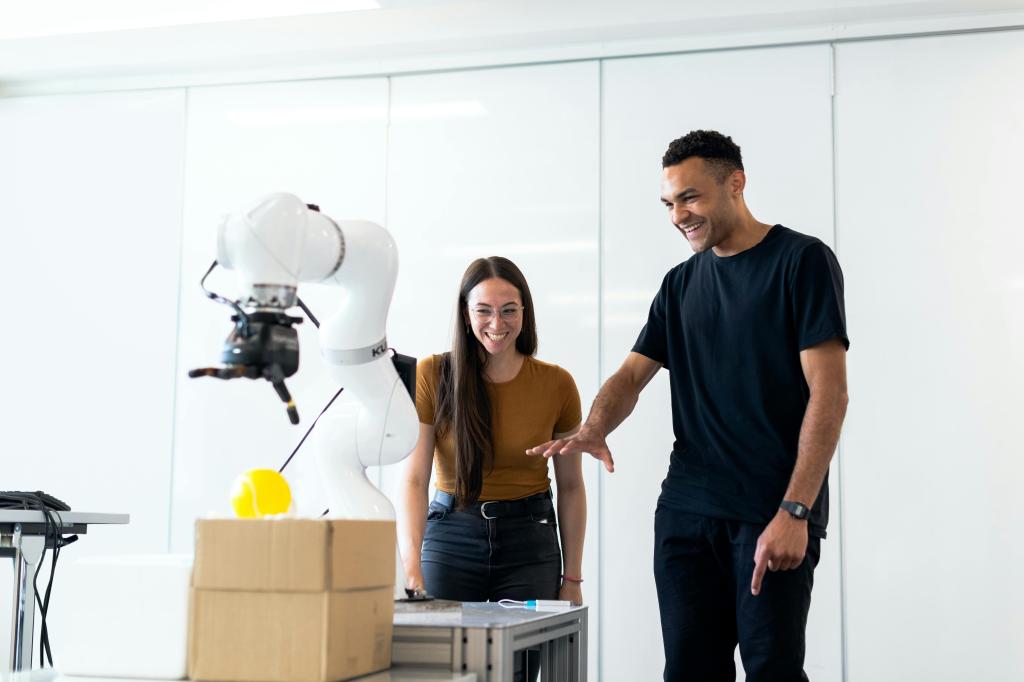 Female scientist and male scientist looking at a robot
