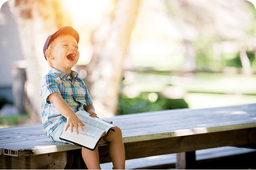 Smiling boy on a park bench