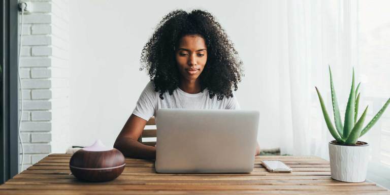 Woman using a laptop to update her fundraiser