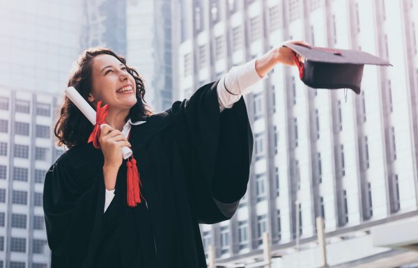Graduation day, Young woman with graduation cap and gown holding diploma, Successful concept