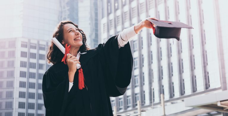 Graduation day, Young woman with graduation cap and gown holding diploma, Successful concept