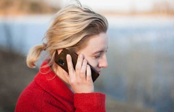 A person sharing the news of her fundraiser using her cellphone