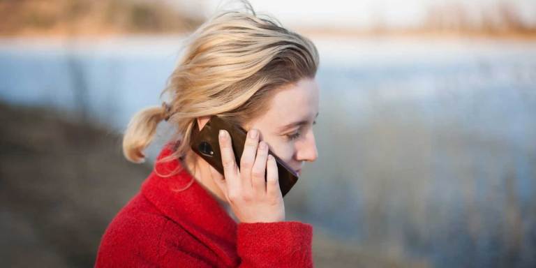A person sharing the news of her fundraiser using her cellphone