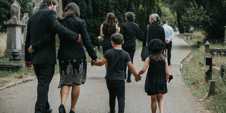 A family leaving a burial