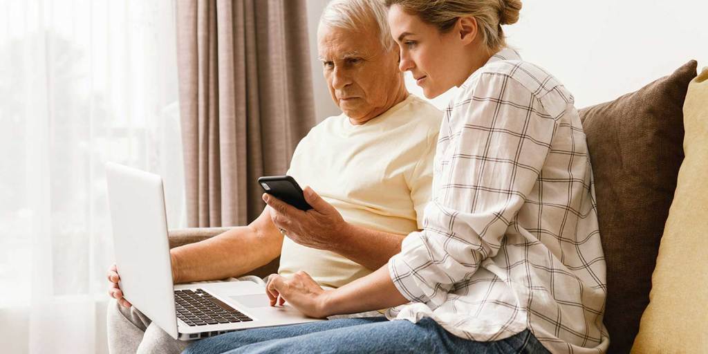 A daughter helping her father set up a fundraiser for medical expenses