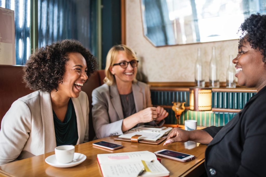 Group of professional women talking at a table