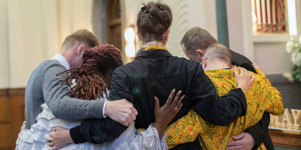 group hug at a funeral