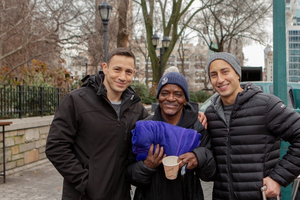 Three young people standing outside