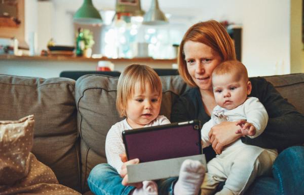Mother reading to her two young kids