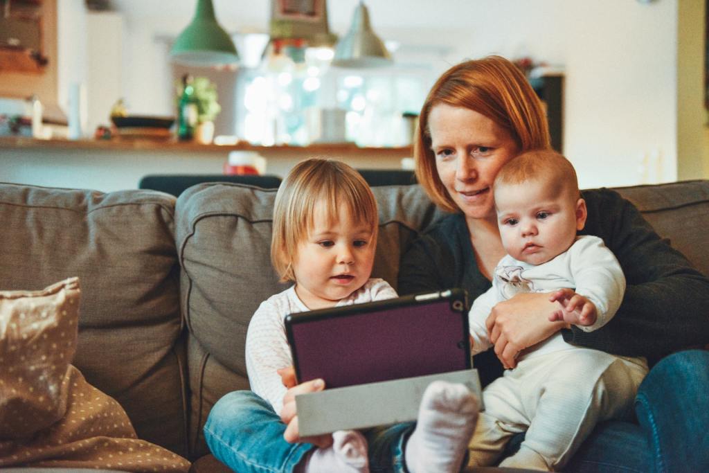 Mother reading to her two young kids