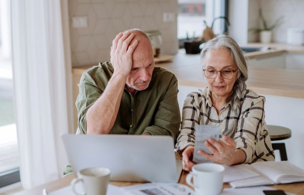 Couple working out debt with a laptop