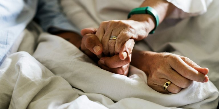 Holding hands with a cancer patient