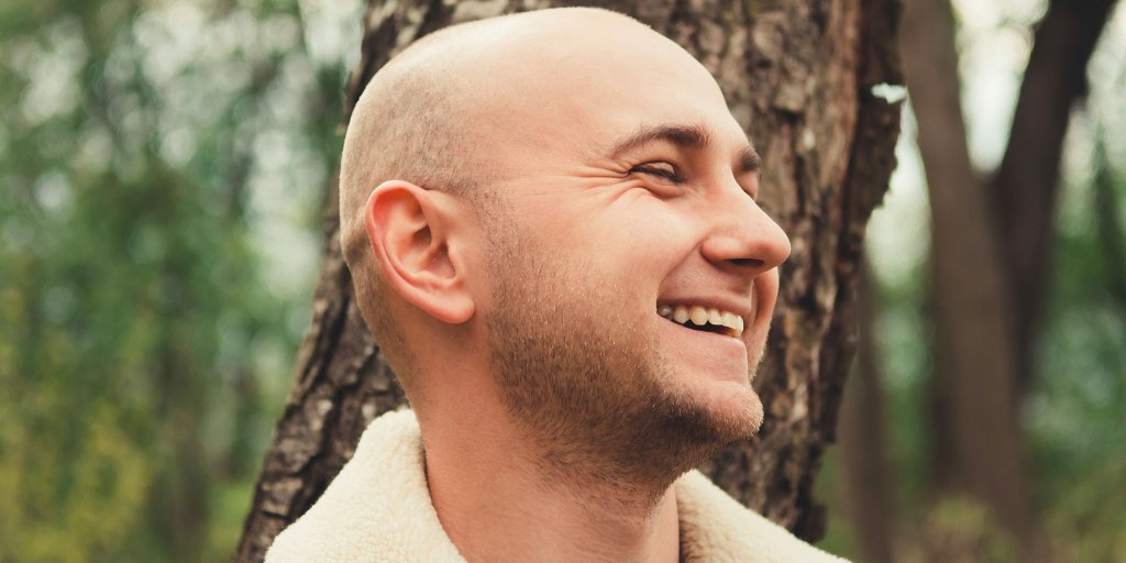 bald person smiling