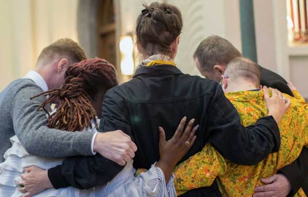 Mourners in a group hug