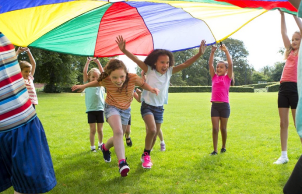 Children playing under a parachute