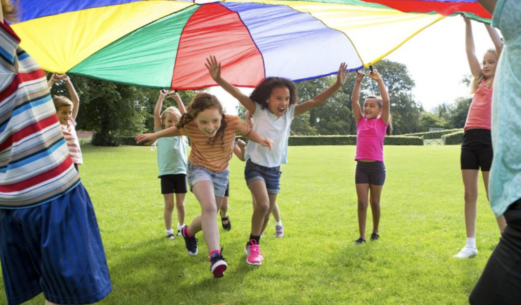 Children playing under a parachute