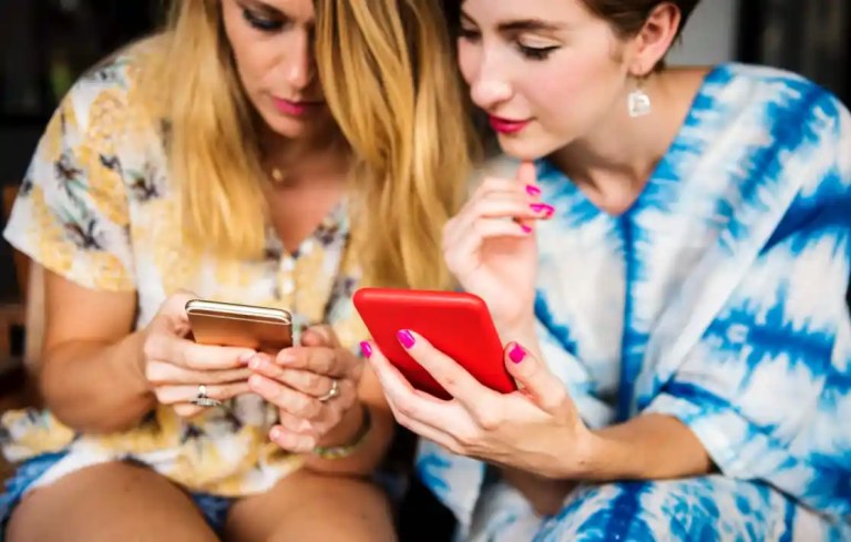 two people looking at a phone