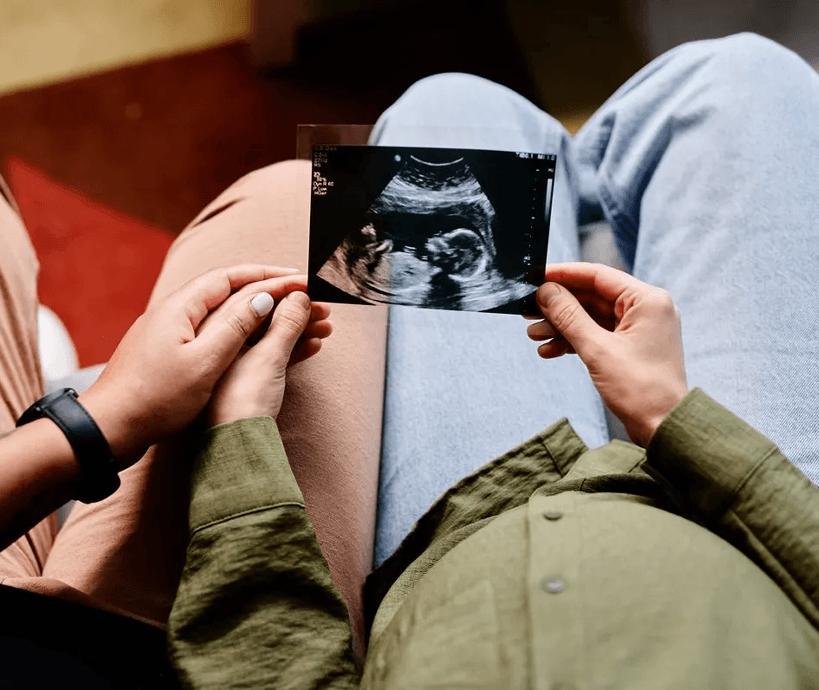 a couple looking at an ultrasound
