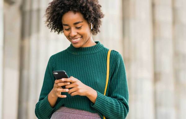 A woman posting an update on her cellphone