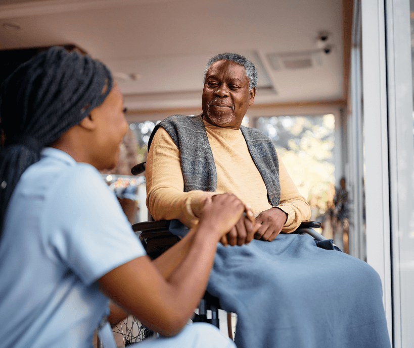 A patient receiving support from a healthcare worker