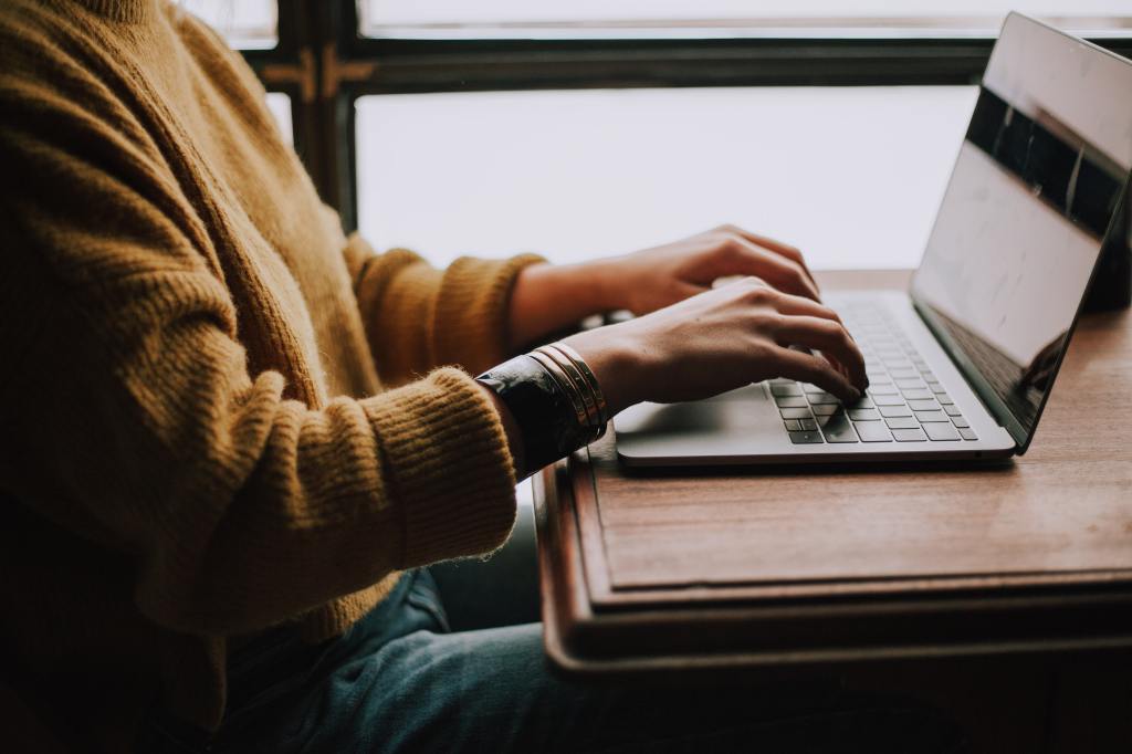 Una persona escribiendo en una computadora portátil