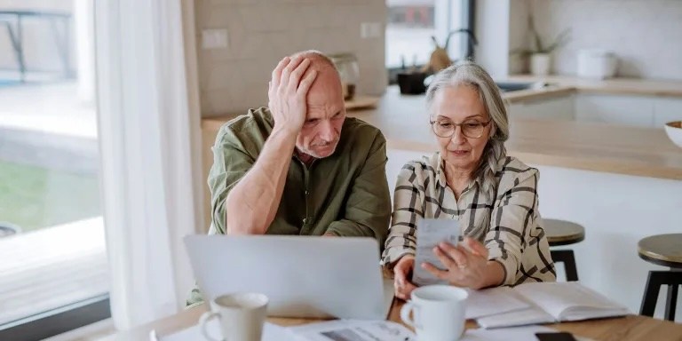 un couple travaillant ensemble devant un ordinateur