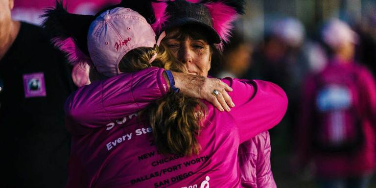 Friends embracing during a cancer fundraiser