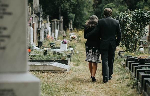 Un homme et une femme se promenant dans un cimetière
